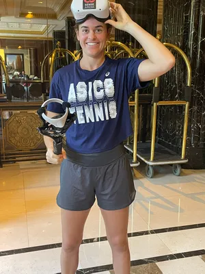 VR Tennis Training User Smiling at camera, headset resting on head
